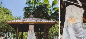 Wedding dress hung outside under palm trees in Ibiza