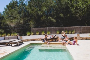 Bridal party relaxing around pool