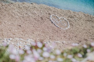 Bride and Grooms initials written in the sand Amante Beach Club Ibiza