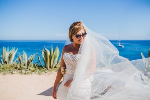 Bride swishing her veil on the beach Ibiza, Spain