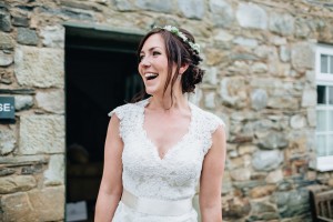 Candid photo of happy bride in front of cottages Lake District