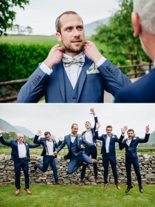 Happy groomsmen jumping in the air in blue suits