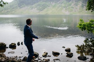 Groom skipping stones on Crummock Water Lake District