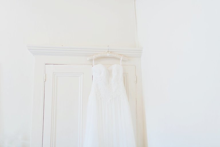 wedding dress hung on wardrobe