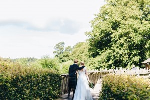 Bride and groom walking to Alnwick treehouse