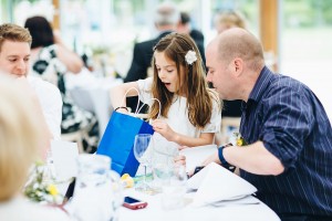 Young girl opening present at wedding