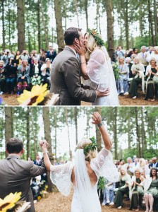Bride and groom kiss in woodland wedding