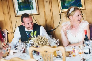 Groom laughing during wedding speeches