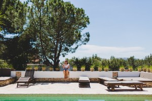Destination wedding in Ibiza, wedding guest sat by swimming pool