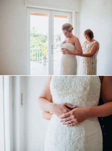 Mother of the bride fastening the wedding dress