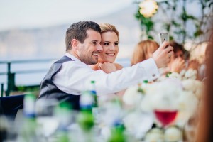 Bride and groom taking selfie in Italy