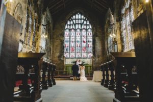 Bride and groom praying in church