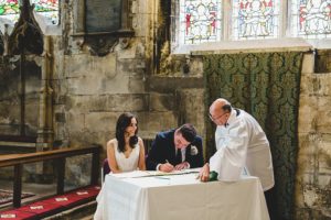 Bride and groom signing register
