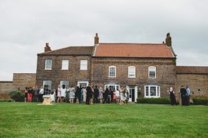 Hornington Manor wedding photographer guests enjoying pimms in the garden