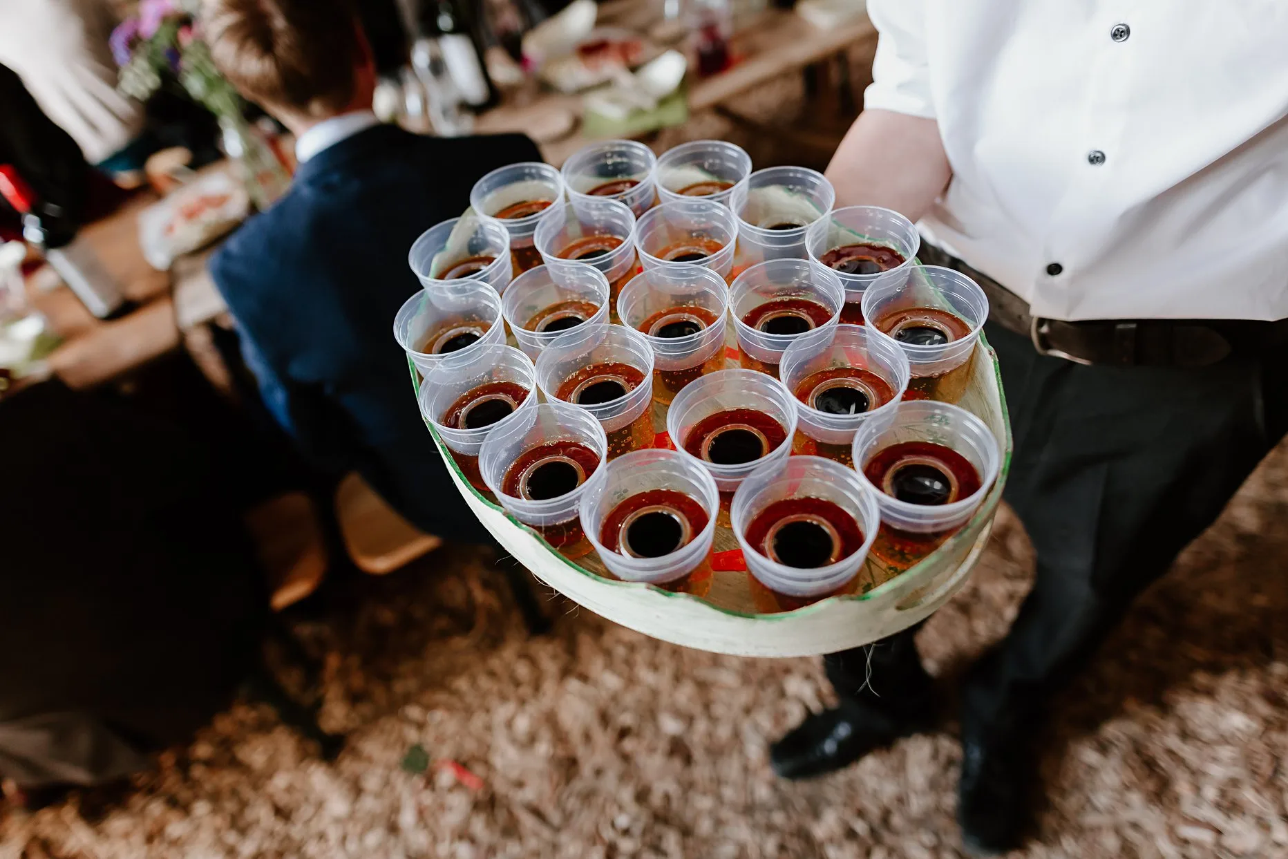 A tray of about 20 Jägerbomb shots held by a wedding guest.