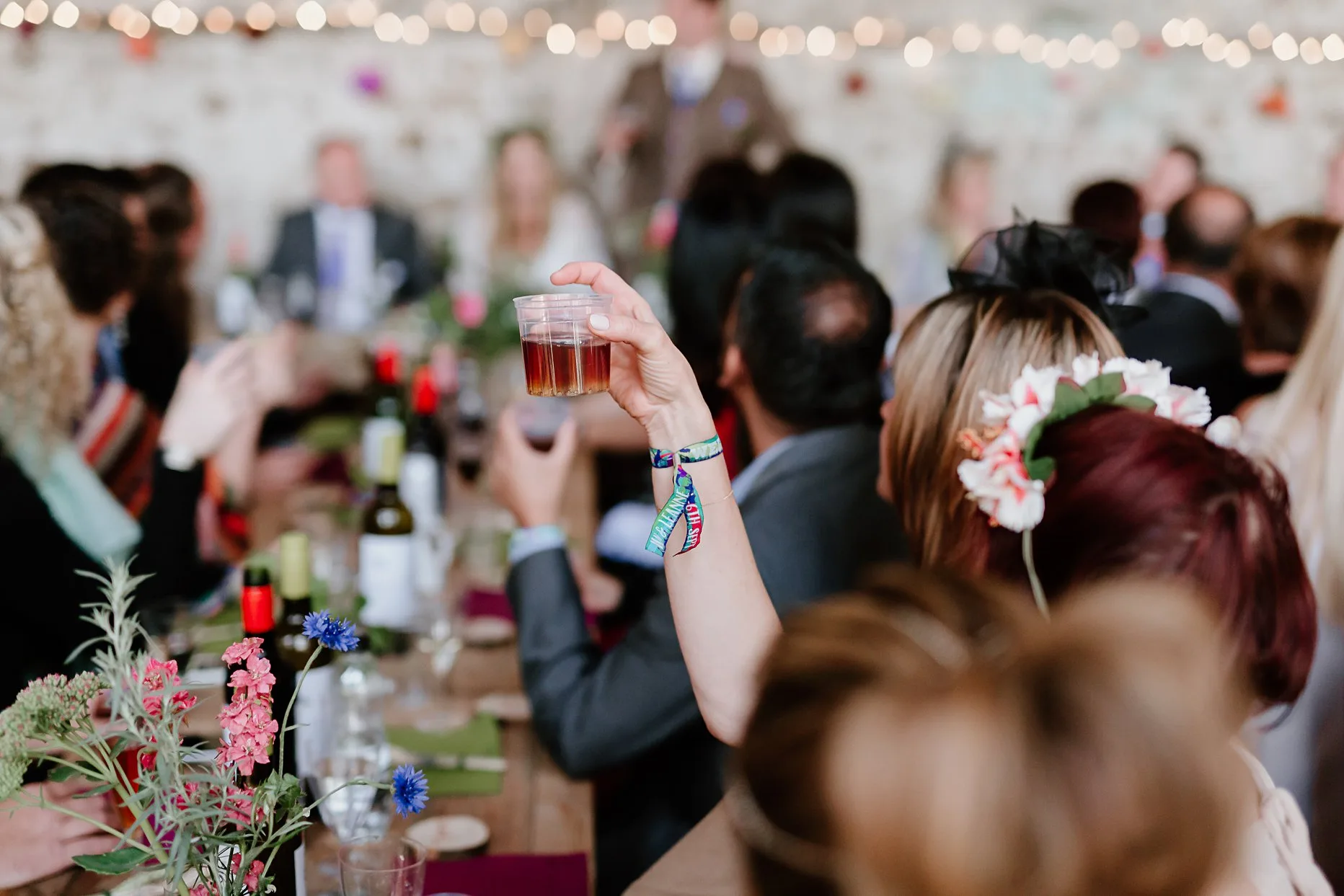 A wedding guest raising a toast with a  jagerbomb shot.