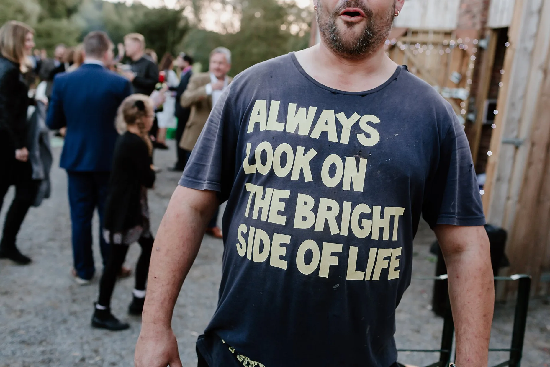 Wedding guest wearing a t-shirt that reads: Always look on the bright side of life.