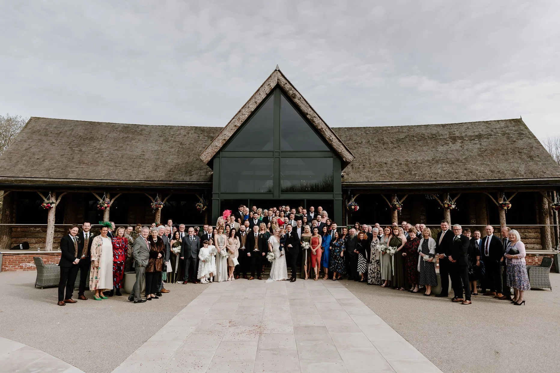 A group photo of all wedding guests stood outside the Grand Lodge at Oaklands.