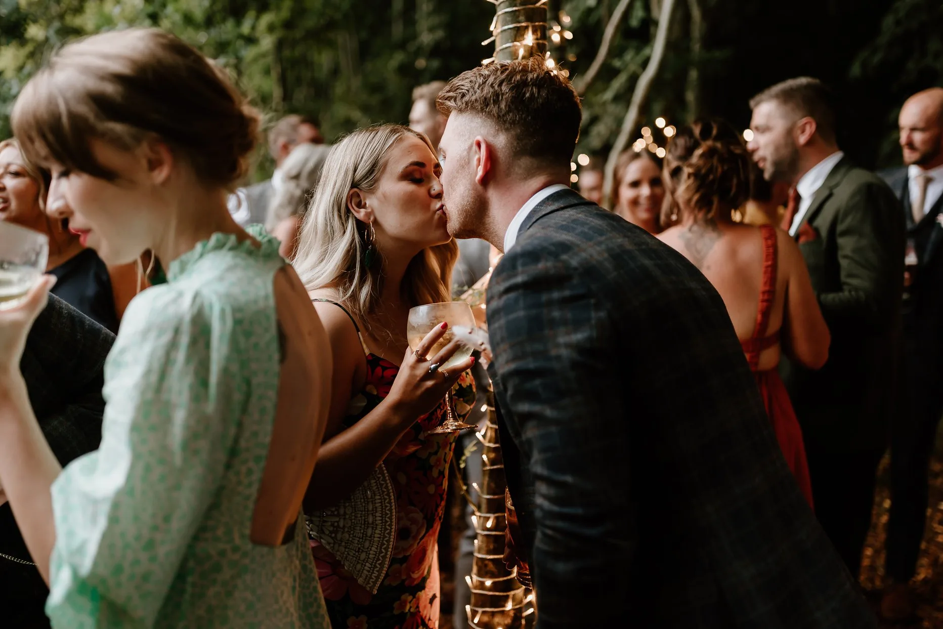 Two wedding guests share a kiss during the dancing at Oaklands Grand Lodge.