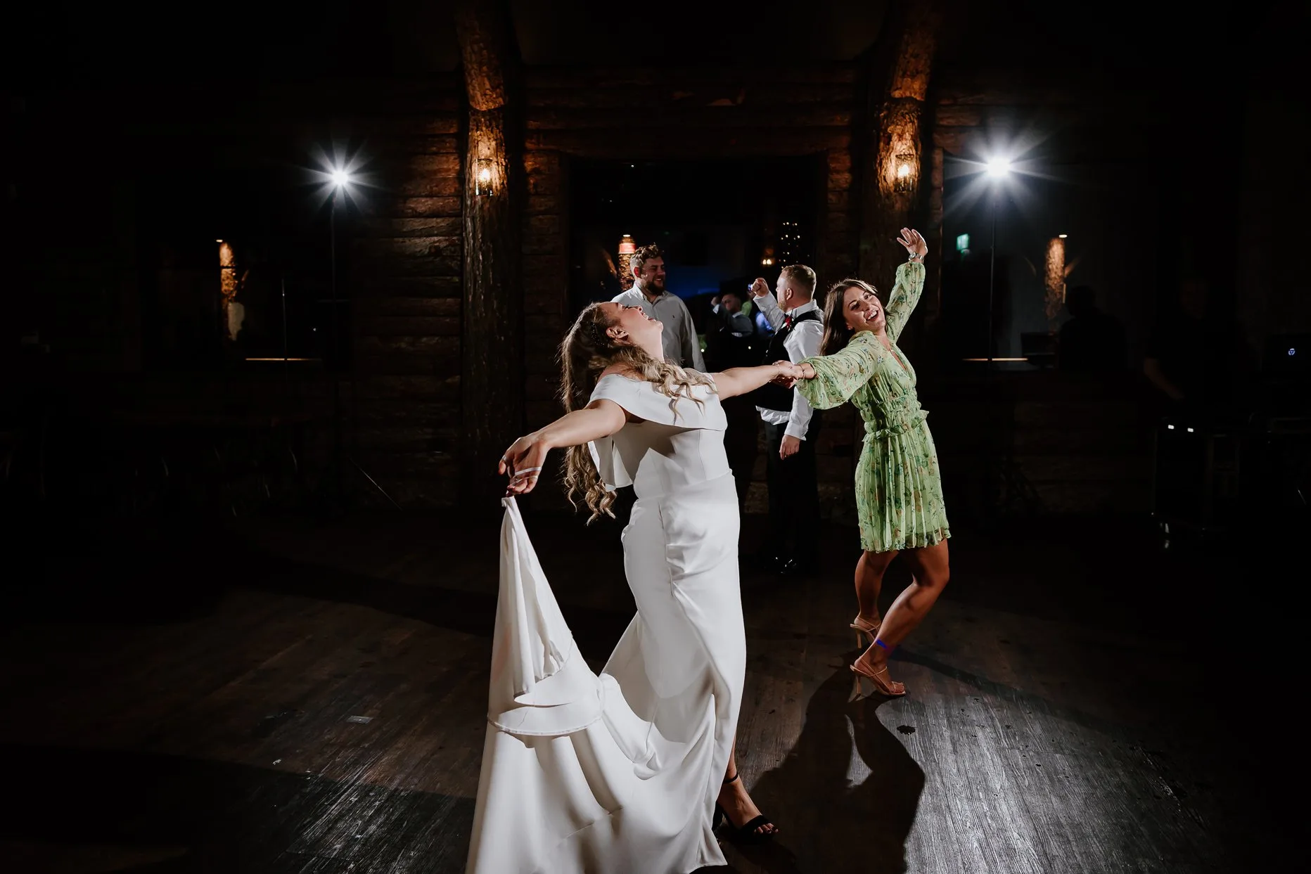Bride and friend dancing on the dance floor at Oaklands Grand Lodge