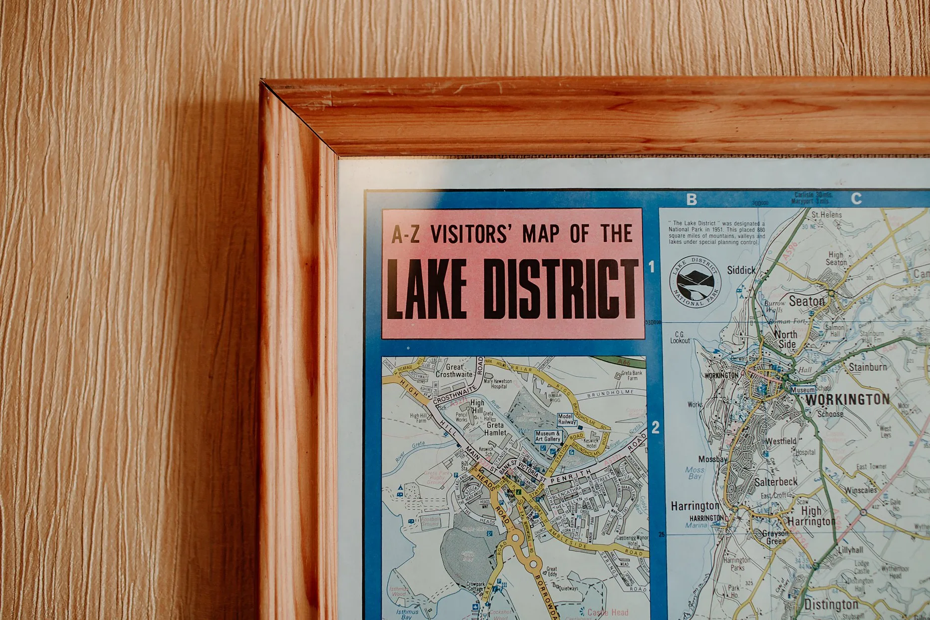 Vintage map of the Lake District in wooden frame hung on a wall.
