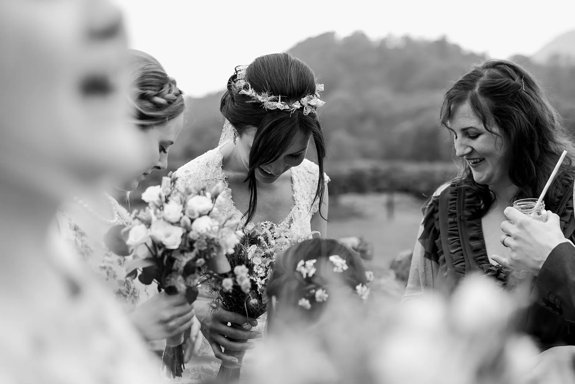Candid photograph of the bride talking to wedding guests during the drinks reception at New House Farm.